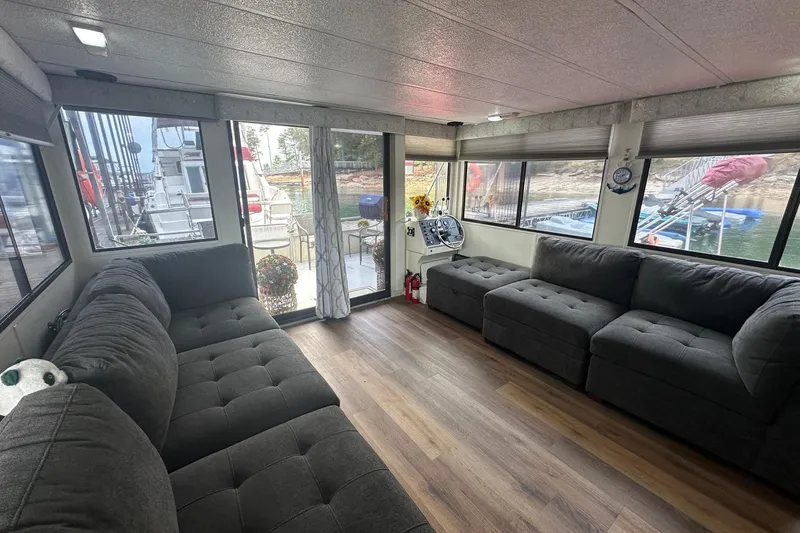 Slide: The Image of Interior of a 1996 Catamaran Cruisers 12x42 with plush seating and large windows. - 5
