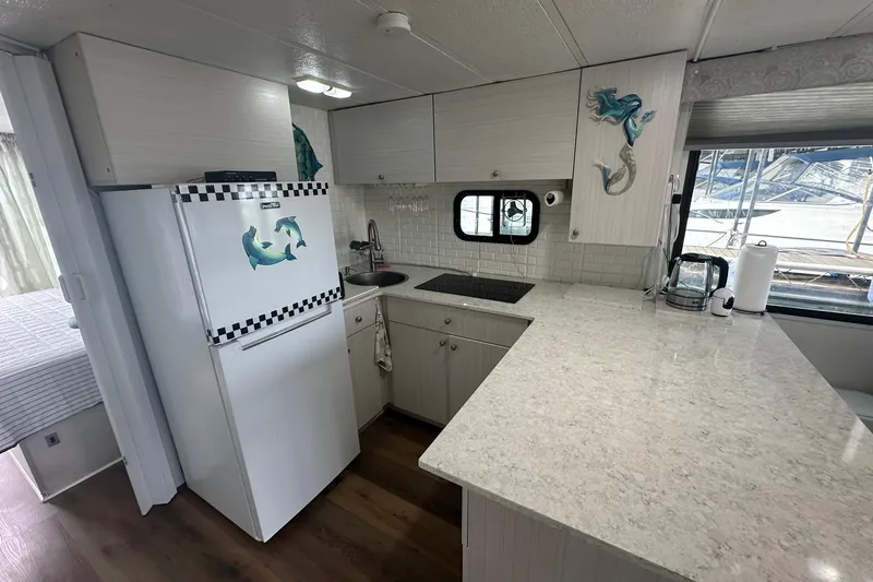 Slide: The Image of Interior of a 1996 Catamaran Cruisers 12x42 with modern kitchen and nautical decor. - 6
