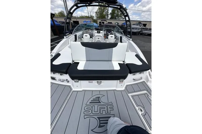 Slide: The Image of 2023 Chaparral 23 Surf boat interior with stylish seating and surf logo on deck. - 10