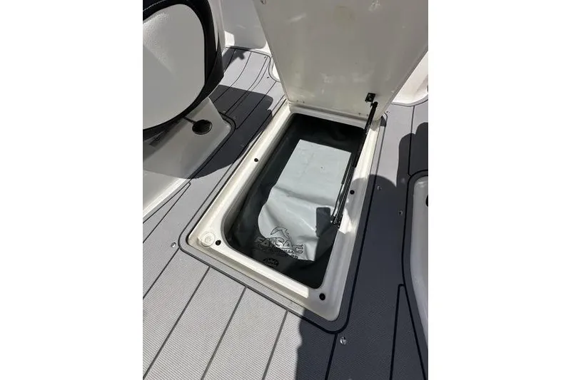 Slide: The Image of Open storage compartment on 2023 Chaparral 23 Surf boat deck. - 11