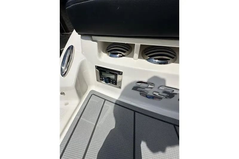 Slide: The Image of 2023 Chaparral 23 Surf boat interior with speakers and control panel. - 15