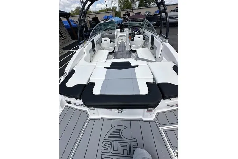 Slide: The Image of 2023 Chaparral 23 Surf boat interior with seating and dashboard view. - 16