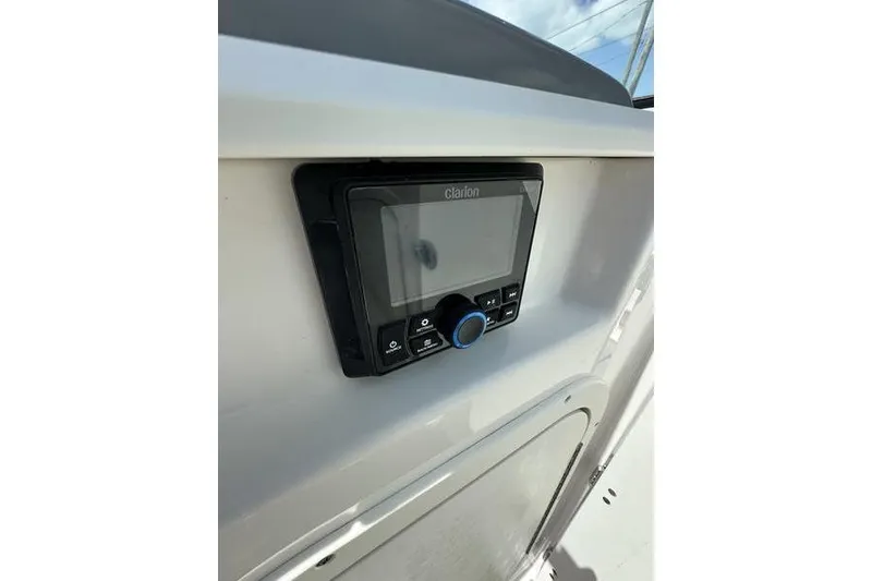 Slide: The Image of 2023 Chaparral 23 Surf boat dashboard with Clarion audio system. - 17