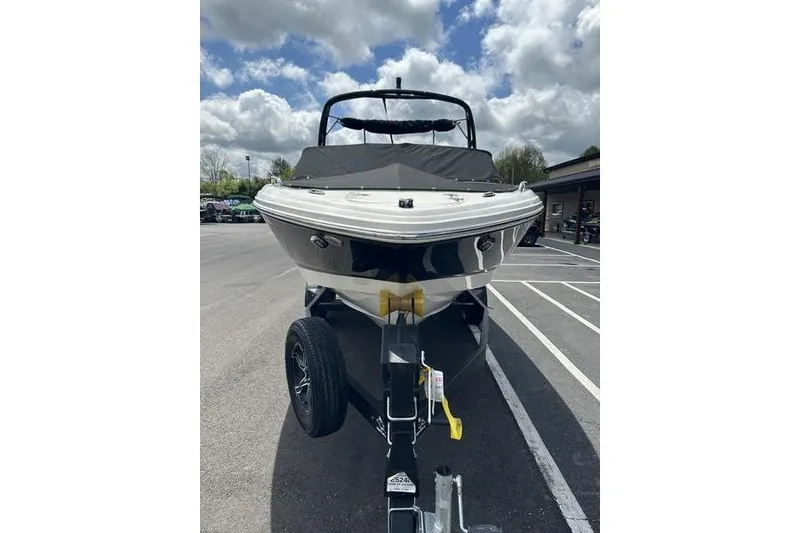Slide: The Image of 2023 Chaparral 23 Surf boat on trailer under cloudy sky. - 36