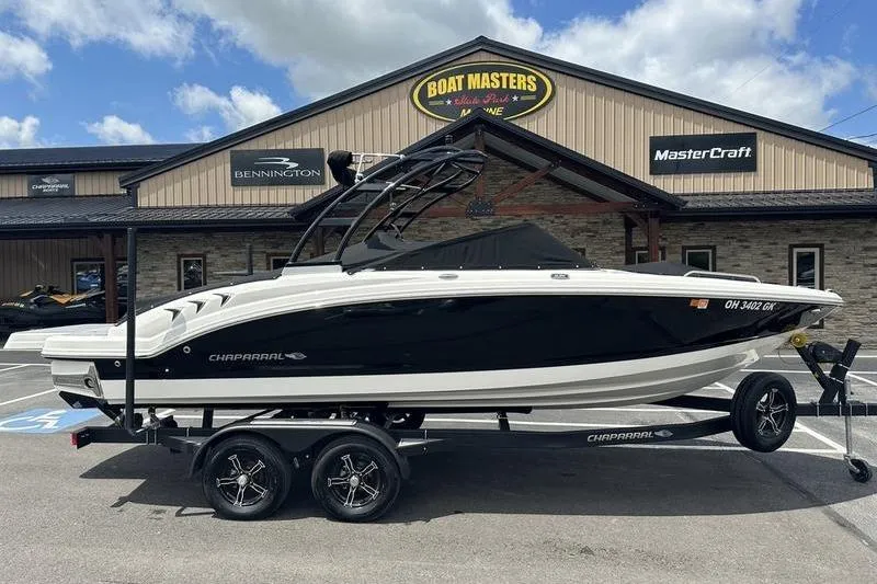 Slide: The Image of 2023 Chaparral 23 Surf boat on trailer, covered, parked outside a building. - 37