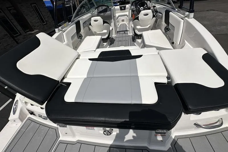 Slide: The Image of 2023 Chaparral 23 Surf boat interior with sleek black and white seating design. - 4