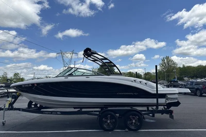 Slide: The Image of 2023 Chaparral 23 Surf boat on trailer under blue sky with clouds. - 5