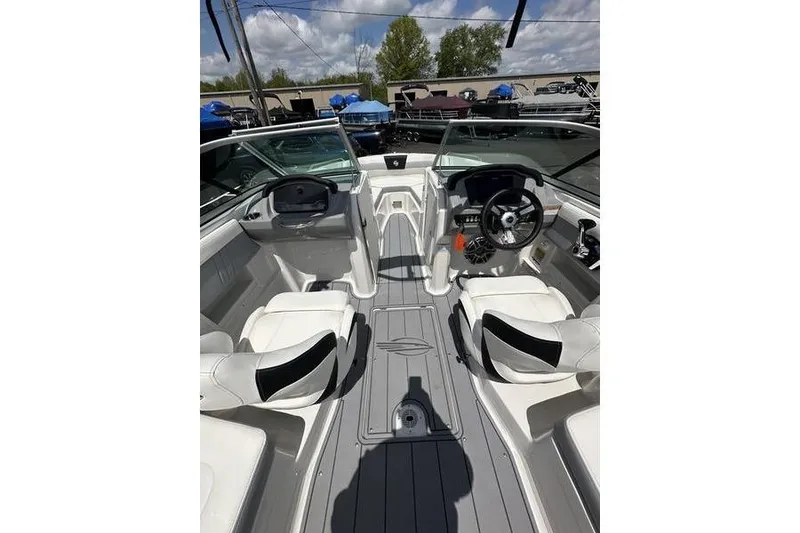 Slide: The Image of 2023 Chaparral 23 Surf boat interior with dual seating and modern dashboard. - 8