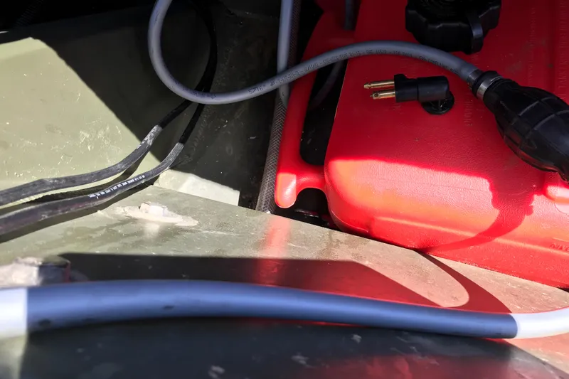 Slide: The Image of Interior of 1992 Alweld 1856VV boat showing cables and red fuel tank. - 10