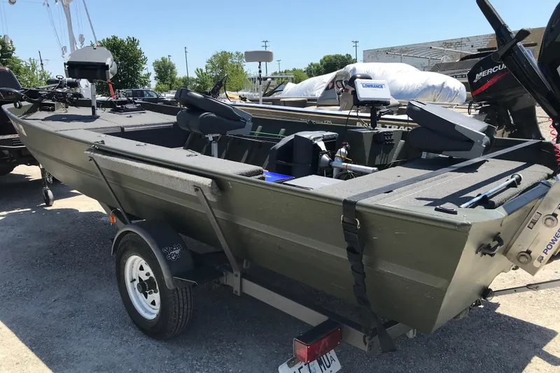 Slide: The Image of 1992 Alweld 1856VV Large Vee Bottom boat on trailer, equipped with fishing gear. - 12