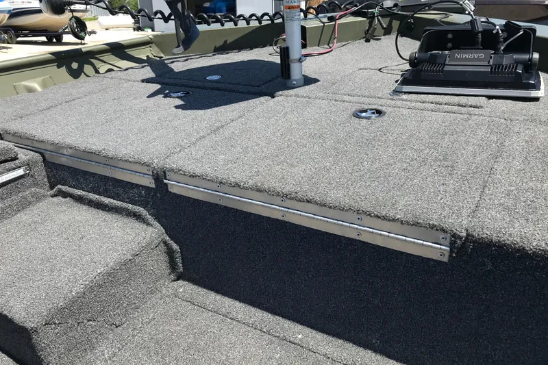 Slide: The Image of Carpeted deck of a 1992 Alweld 1856VV Large Vee Bottom boat with Garmin equipment. - 13