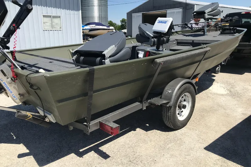 Slide: The Image of 1992 Alweld 1856VV Large Vee Bottom boat on trailer, equipped with fishing gear. - 17