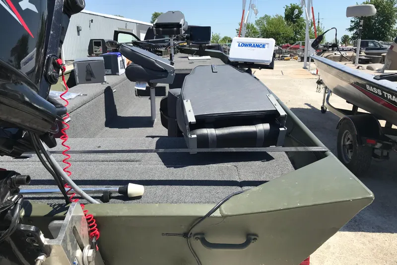 Slide: The Image of 1992 Alweld 1856VV Large Vee Bottom boat with Lowrance equipment, parked outdoors. - 25