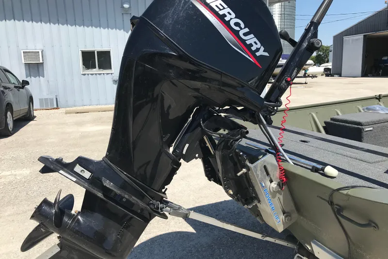 Slide: The Image of Outboard motor on 1992 Alweld 1856VV Large Vee Bottom boat, parked outdoors. - 31