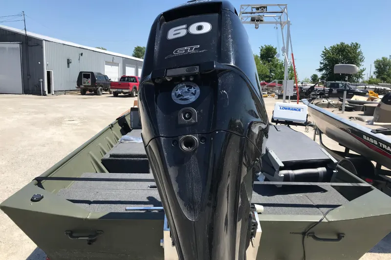 Slide: The Image of 1992 Alweld 1856VV Large Vee Bottom boat with 60 HP motor in a marina. - 32