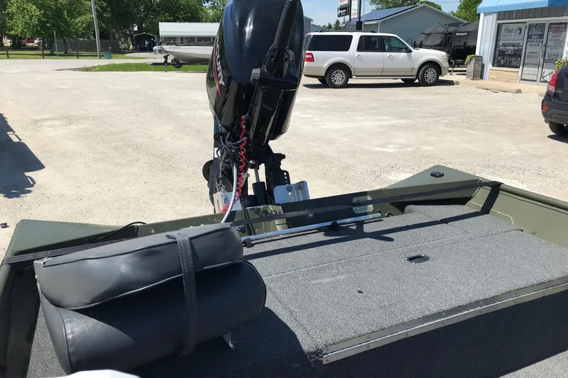 Slide: The Image of 1992 Alweld 1856VV Large Vee Bottom boat with Mercury outboard motor in a parking lot. - 39