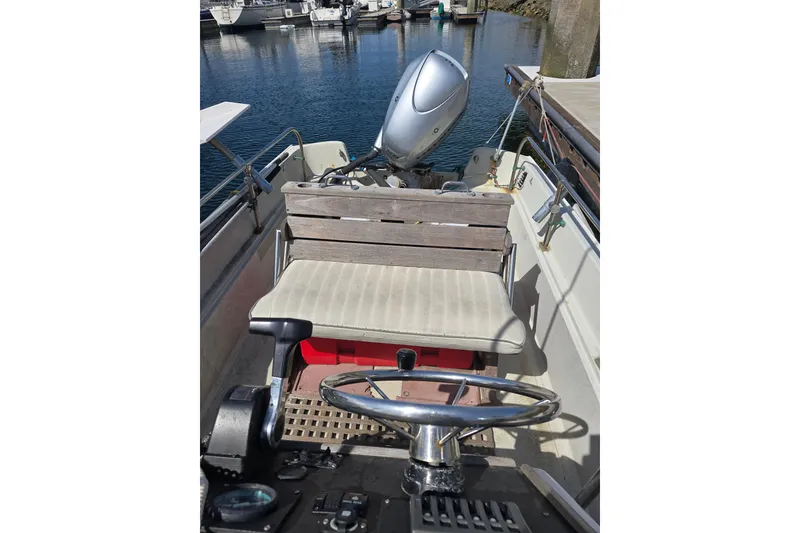Slide: The Image of 1993 Boston Whaler 17 Montauk boat interior with steering wheel and outboard motor. - 4