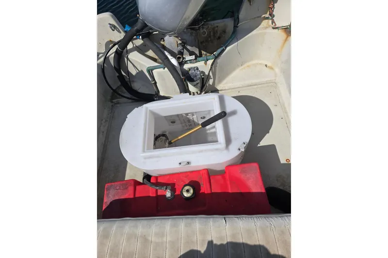Slide: The Image of 1993 Boston Whaler 17 Montauk interior with red fuel tank and engine components. - 5