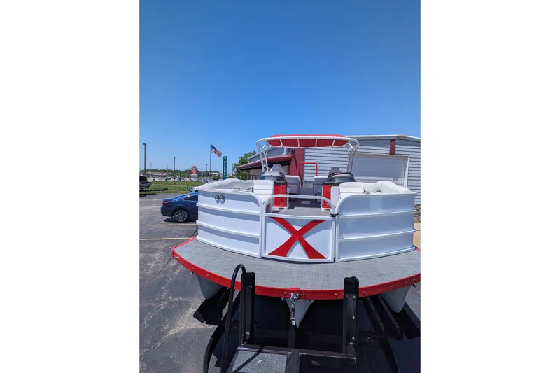 The Image of 2025 PlayCraft 3000 XTREME pontoon boat with red accents, parked outdoors. - 0