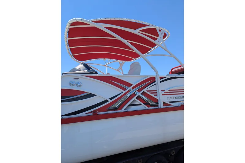 Slide: The Image of 2025 PlayCraft 3000 XTREME boat with red canopy and sleek design. - 1