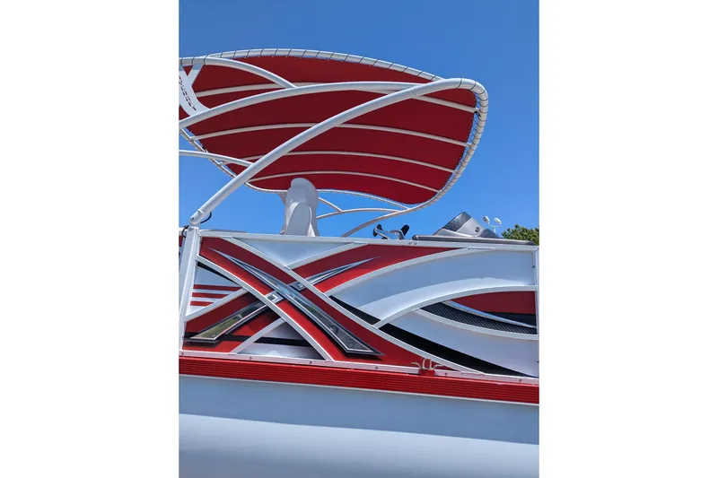 Slide: The Image of 2025 PlayCraft 3000 XTREME boat with sleek red and white design under clear blue sky. - 12