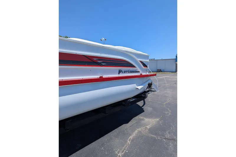 Slide: The Image of 2025 PlayCraft 3000 XTREME boat with red and black accents on a sunny day. - 13