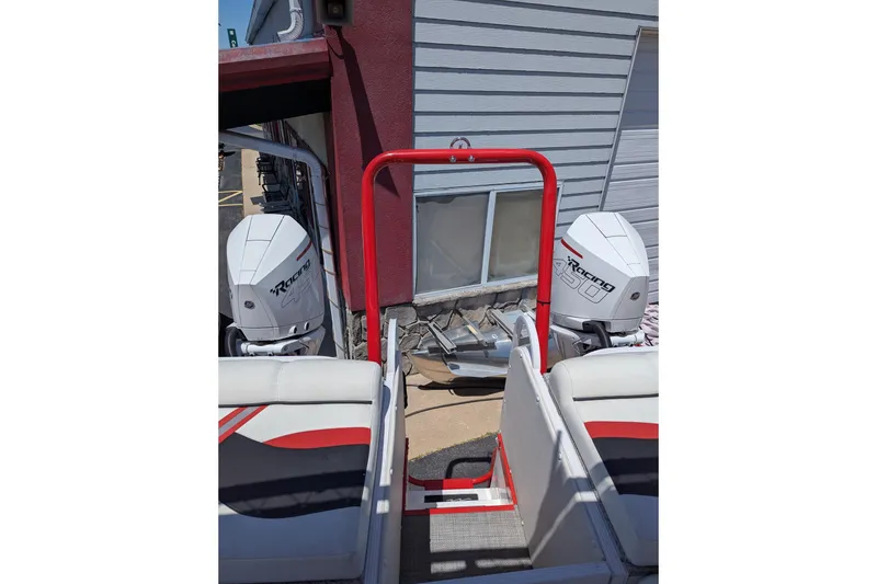 Slide: The Image of 2025 PlayCraft 3000 XTREME boat with dual Racing 450 engines, docked near a building. - 3