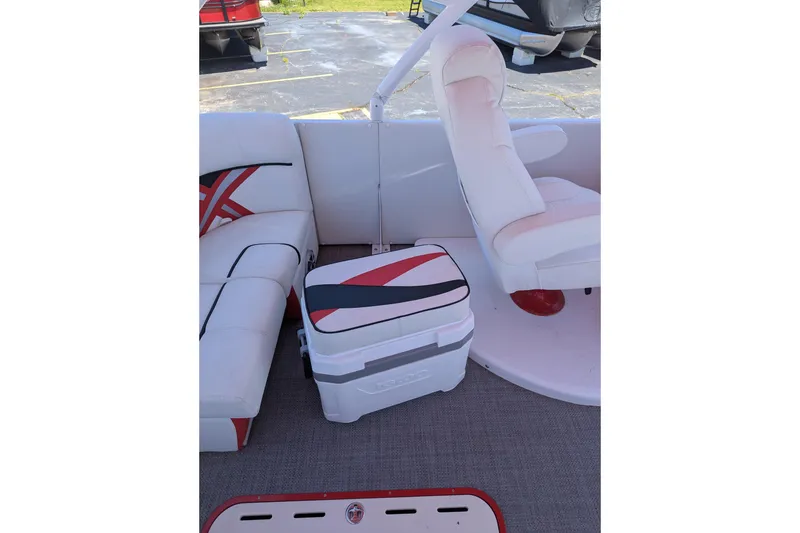 Slide: The Image of Interior of 2025 PlayCraft 3000 XTREME boat with white seating and cooler. - 5