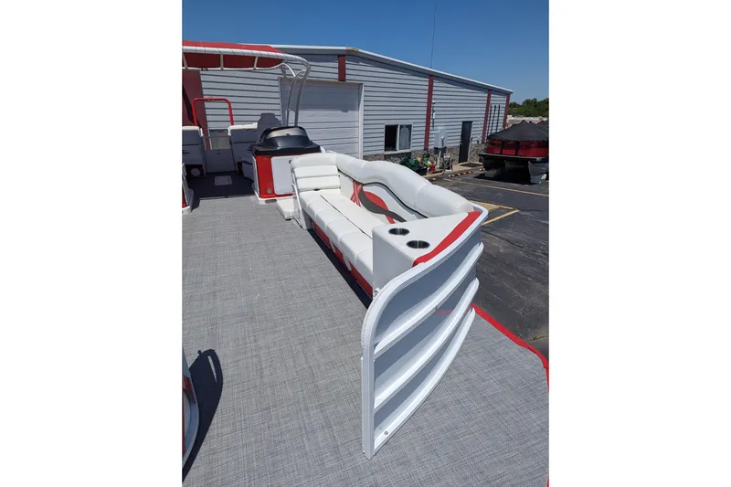 Slide: The Image of 2025 PlayCraft 3000 XTREME pontoon boat with white and red seating, docked outdoors. - 9