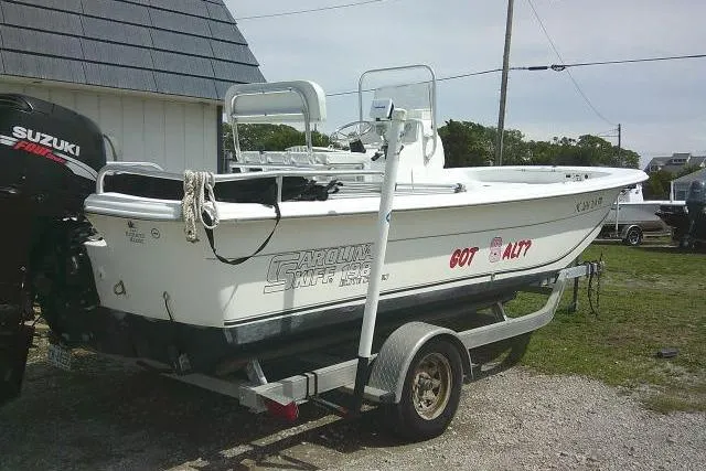 Slide: The Image of 2009 Carolina Skiff 198 DLV Elite boat on trailer, featuring Suzuki outboard motor. - 1