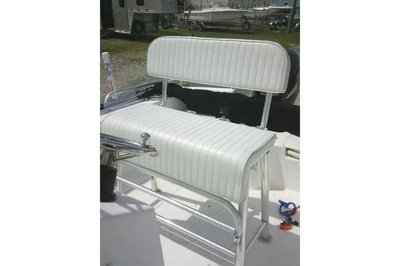 Slide: The Image of 2009 Carolina Skiff 198 DLV Elite boat seat with white upholstery and stainless steel frame. - 12
