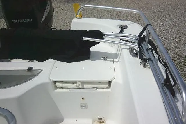 Slide: The Image of 2009 Carolina Skiff 198 DLV Elite boat interior with Suzuki engine, featuring seating and railing. - 13