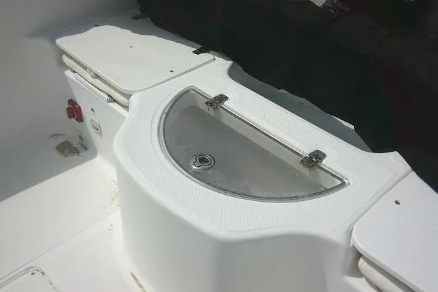 Slide: The Image of 2009 Carolina Skiff 198 DLV Elite boat interior with storage compartment and seating. - 14