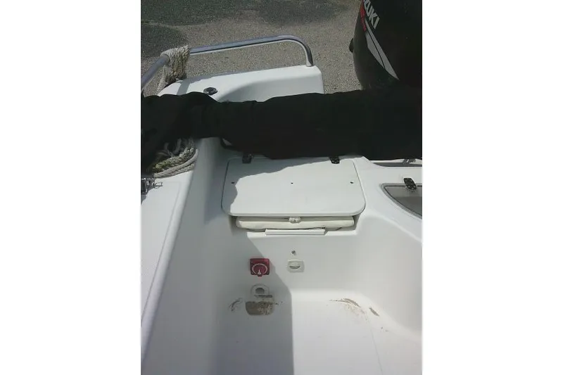 Slide: The Image of 2009 Carolina Skiff 198 DLV Elite boat interior with storage compartment and motor. - 18