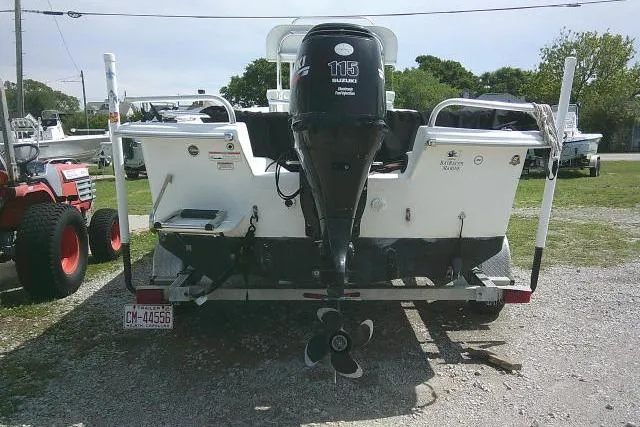 Slide: The Image of 2009 Carolina Skiff 198 DLV Elite boat with Suzuki 115 outboard motor, parked on gravel. - 3