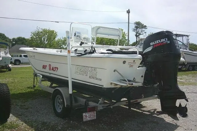 Slide: The Image of 2009 Carolina Skiff 198 DLV Elite boat on trailer with Suzuki outboard motor. - 6