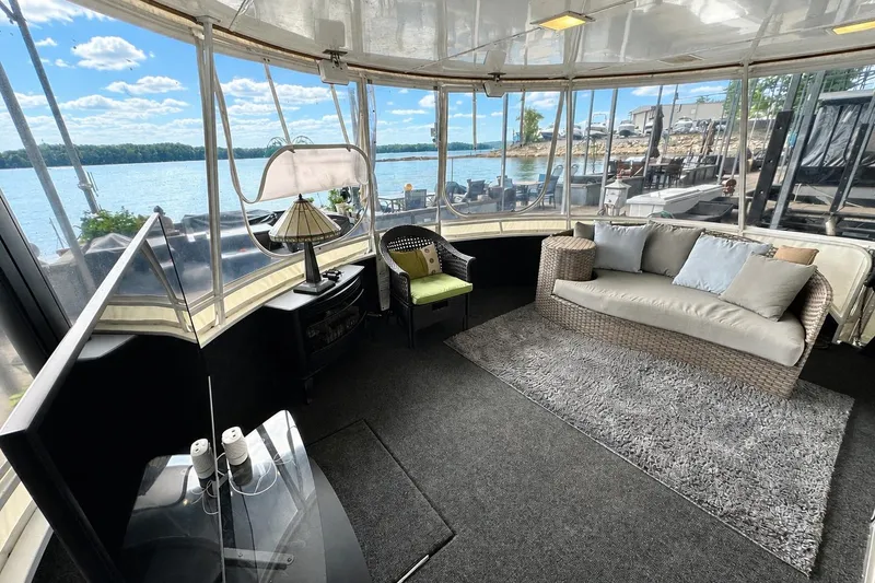 Slide: The Image of Interior of 1993 Lazy Days 16x65 houseboat with lake view, cozy seating, and modern decor. - 1
