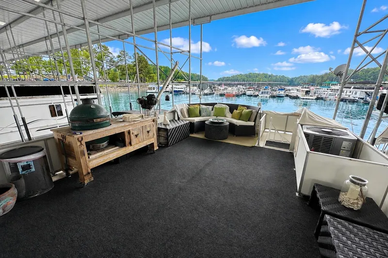 Slide: The Image of Spacious deck on 1993 Lazy Days 16x65 houseboat with seating and grill, overlooking marina. - 14