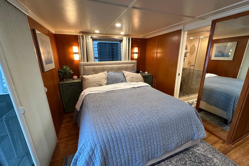 Slide: The Image of Cozy bedroom in a 1993 Lazy Days 16x65 houseboat with modern decor and soft lighting. - 8