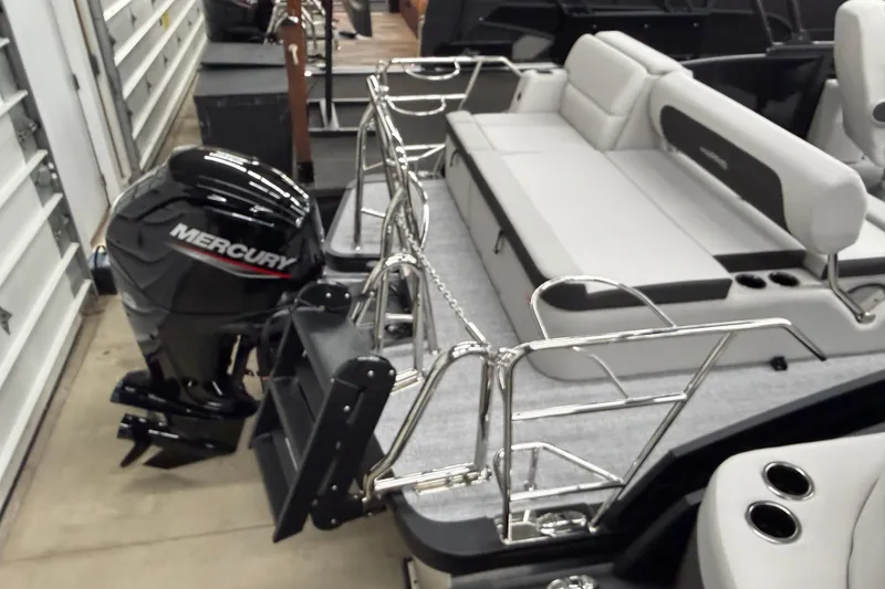 Slide: The Image of 2026 Harris Cruiser 210 SLDH pontoon boat with Mercury outboard motor, docked indoors. - 11