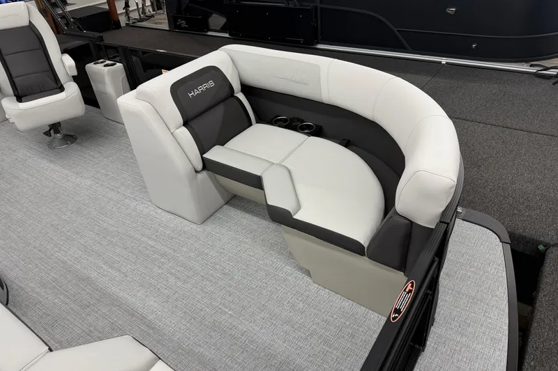 Slide: The Image of 2026 Harris Cruiser 210 SLDH boat interior with plush seating and cup holders. - 3