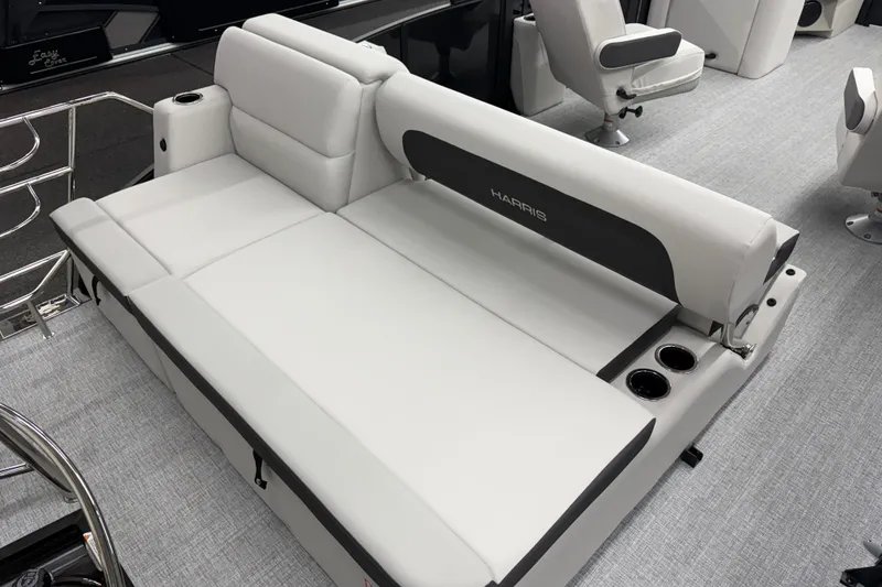 Slide: The Image of 2026 Harris Cruiser 210 SLDH boat interior with plush seating and cup holders. - 8