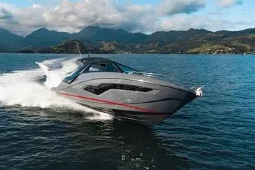 The Image of 2025 NX Boats NX44 PININFARINA cruising on a scenic lake with mountainous backdrop. - 1