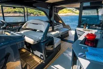Slide: The Image of Luxurious interior of 2025 NX Boats NX44 PININFARINA yacht with modern seating and kitchen area. - 10