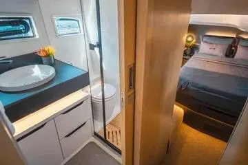 Slide: The Image of Luxurious interior of 2025 NX Boats NX44 PININFARINA, featuring modern bathroom and cozy bedroom. - 11