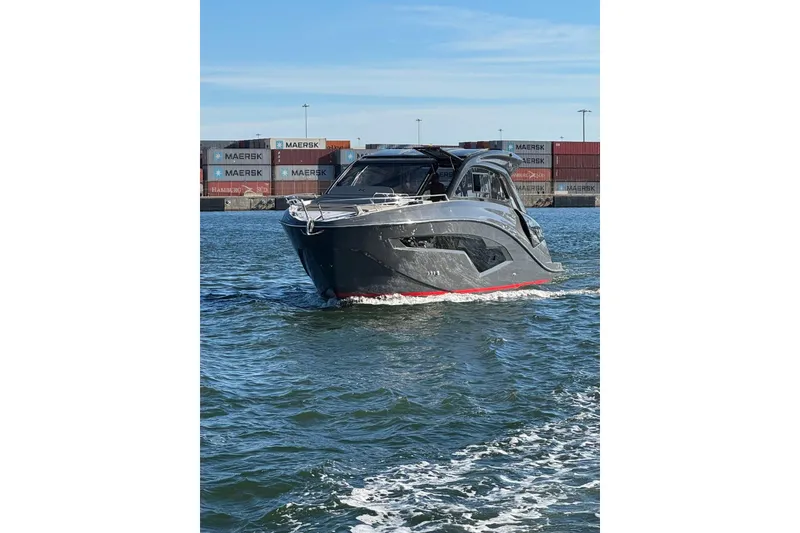 Slide: The Image of 2025 NX Boats NX44 PININFARINA luxury yacht cruising near shipping containers. - 16