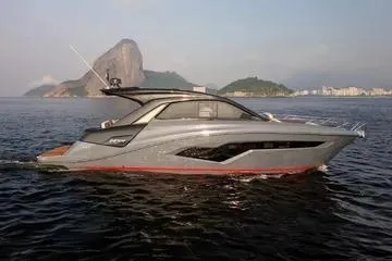Slide: The Image of 2025 NX Boats NX44 PININFARINA yacht cruising on serene waters with scenic coastal backdrop. - 4