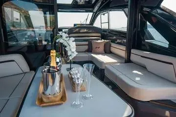 Slide: The Image of Luxurious interior of 2025 NX Boats NX44 PININFARINA with elegant seating and champagne setup. - 6