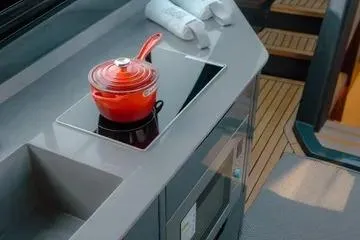 Slide: The Image of Modern kitchen area on 2025 NX Boats NX44 PININFARINA yacht with sleek design. - 7