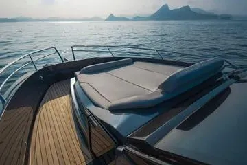 Slide: The Image of 2025 NX Boats NX44 PININFARINA yacht on serene water with scenic mountain backdrop. - 9